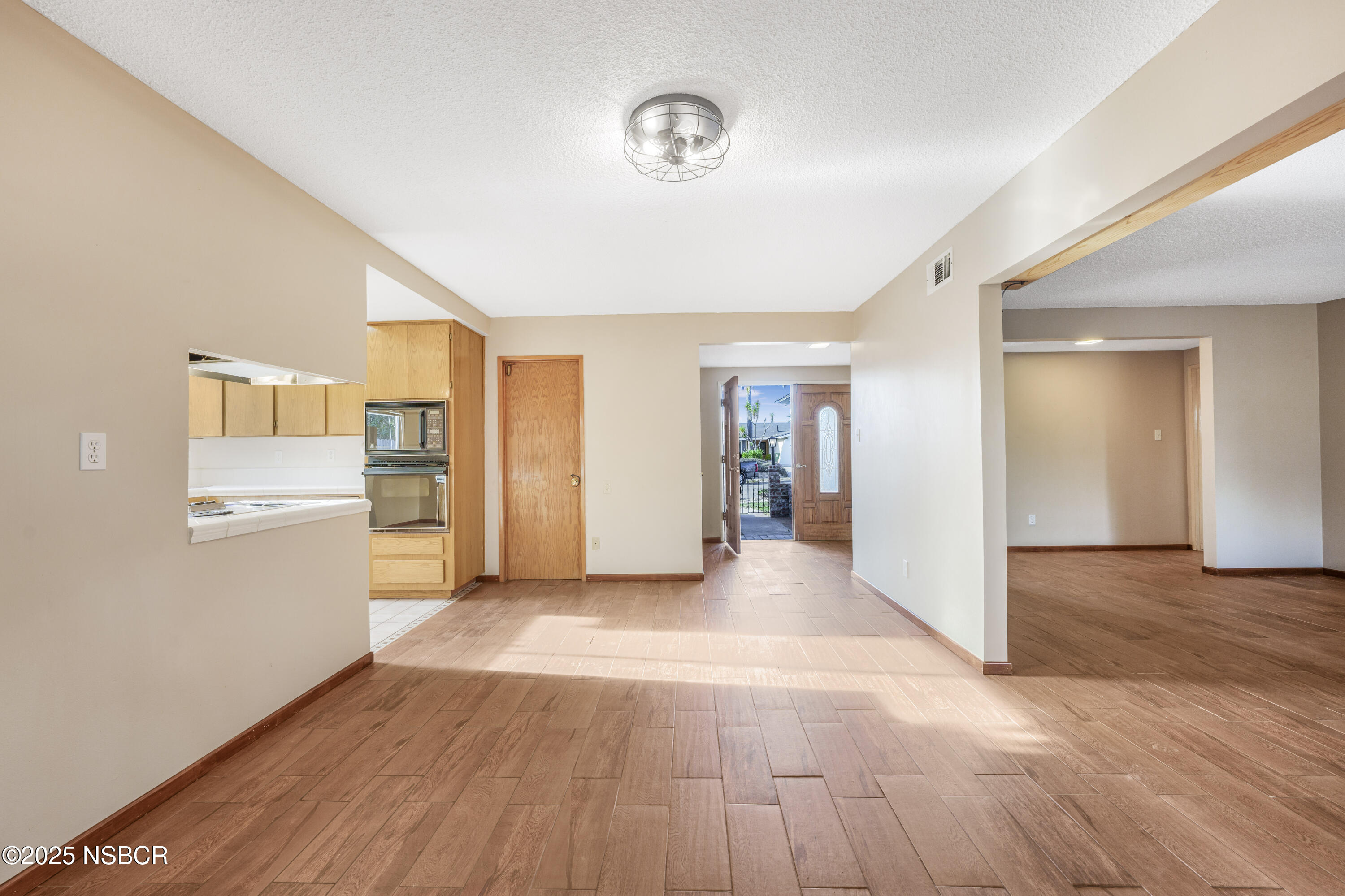 252 Pegasus Avenue Lompoc, CA 93436 - Photo 6 of 33 a view of a kitchen with wooden floor and windows