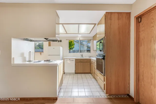 a large kitchen with a lot of counter space and a window