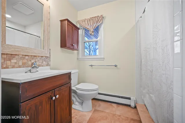 a bathroom with a sink toilet and mirror