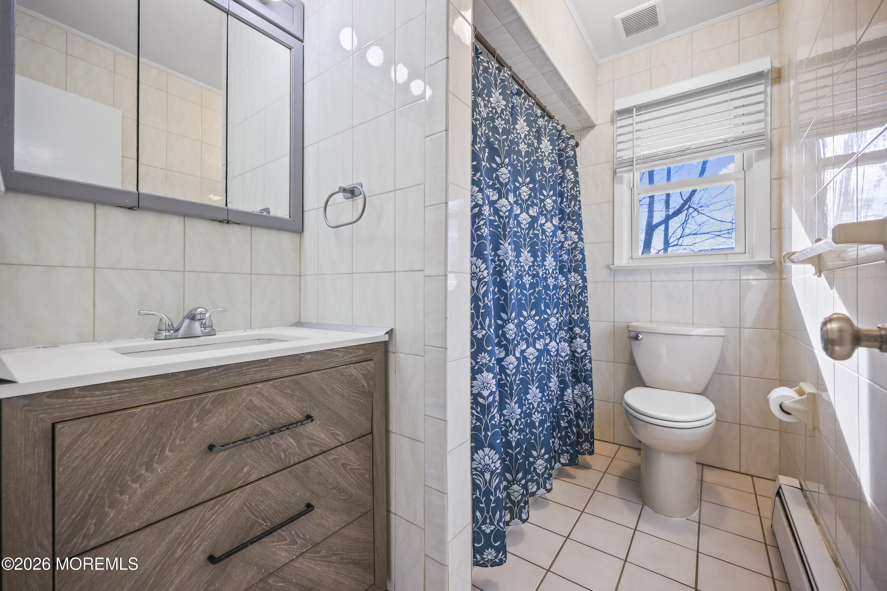 573 Lloyd Road Aberdeen, NJ 07747 - Photo 14 of 23 a bathroom with a sink a toilet and shower