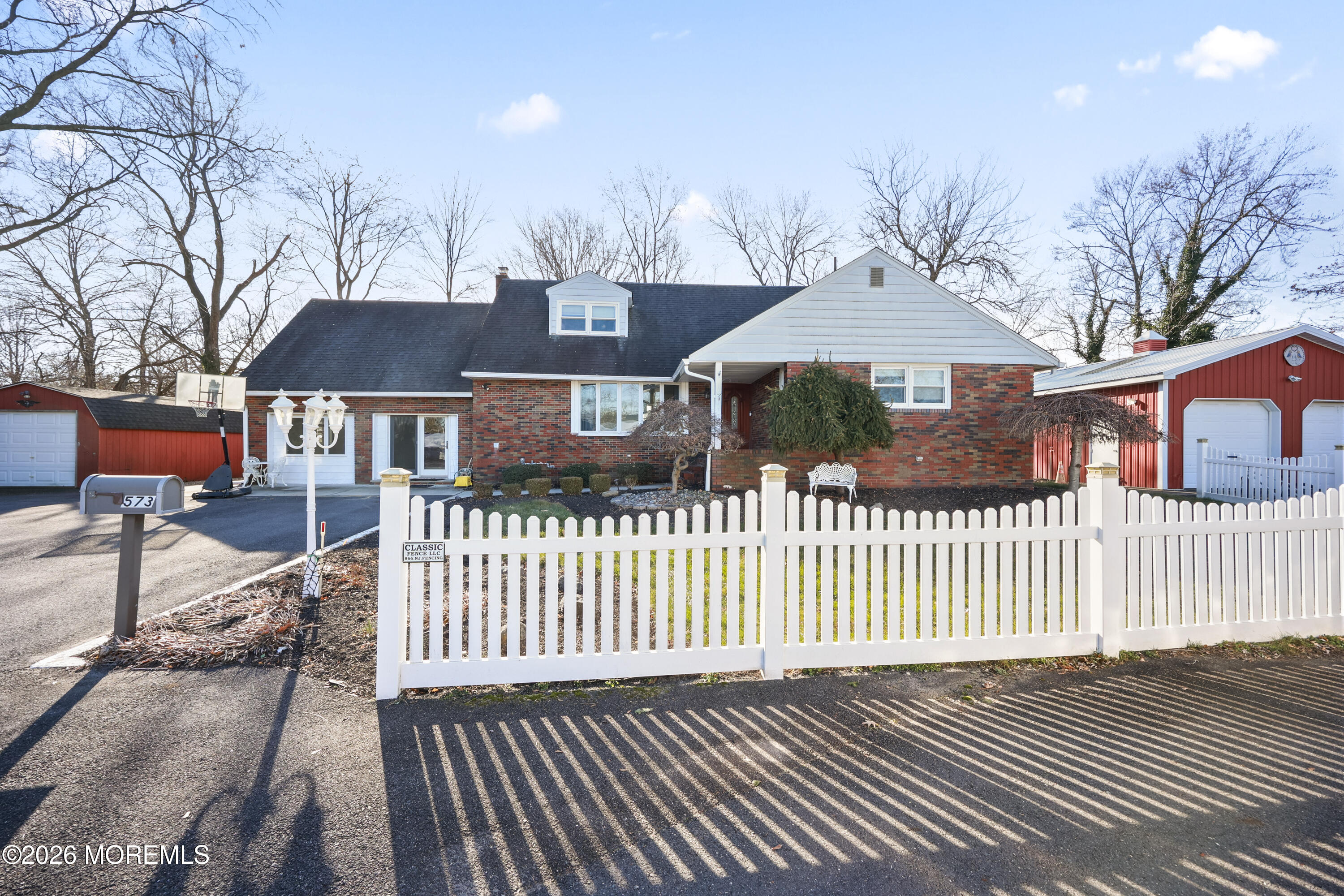 573 Lloyd Road Aberdeen, NJ 07747 - Photo 2 of 23 a front view of a house with a garden