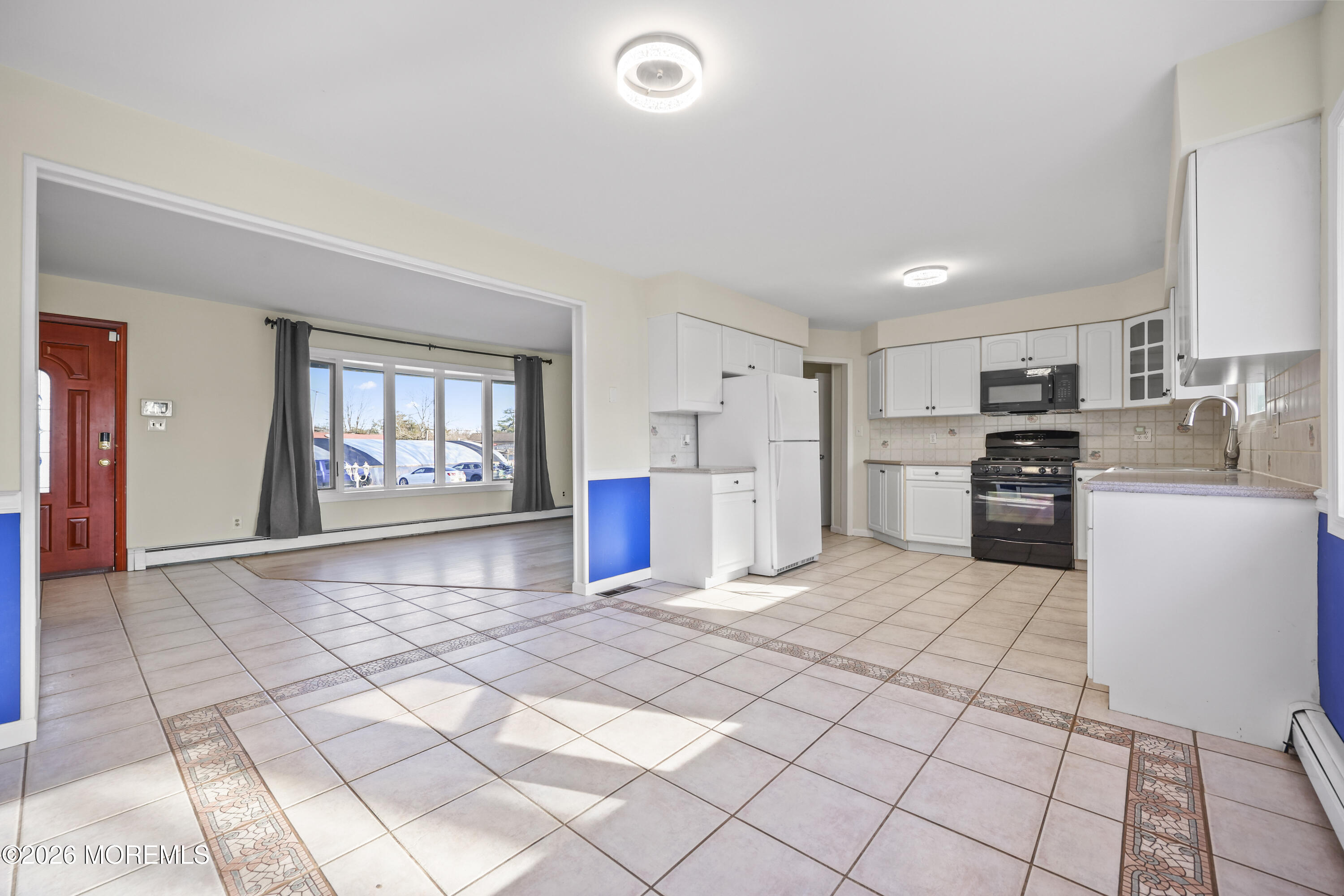 573 Lloyd Road Aberdeen, NJ 07747 - Photo 7 of 23 a large white kitchen with cabinets and a refrigerator