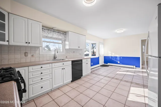 a kitchen with granite countertop a sink cabinets and window