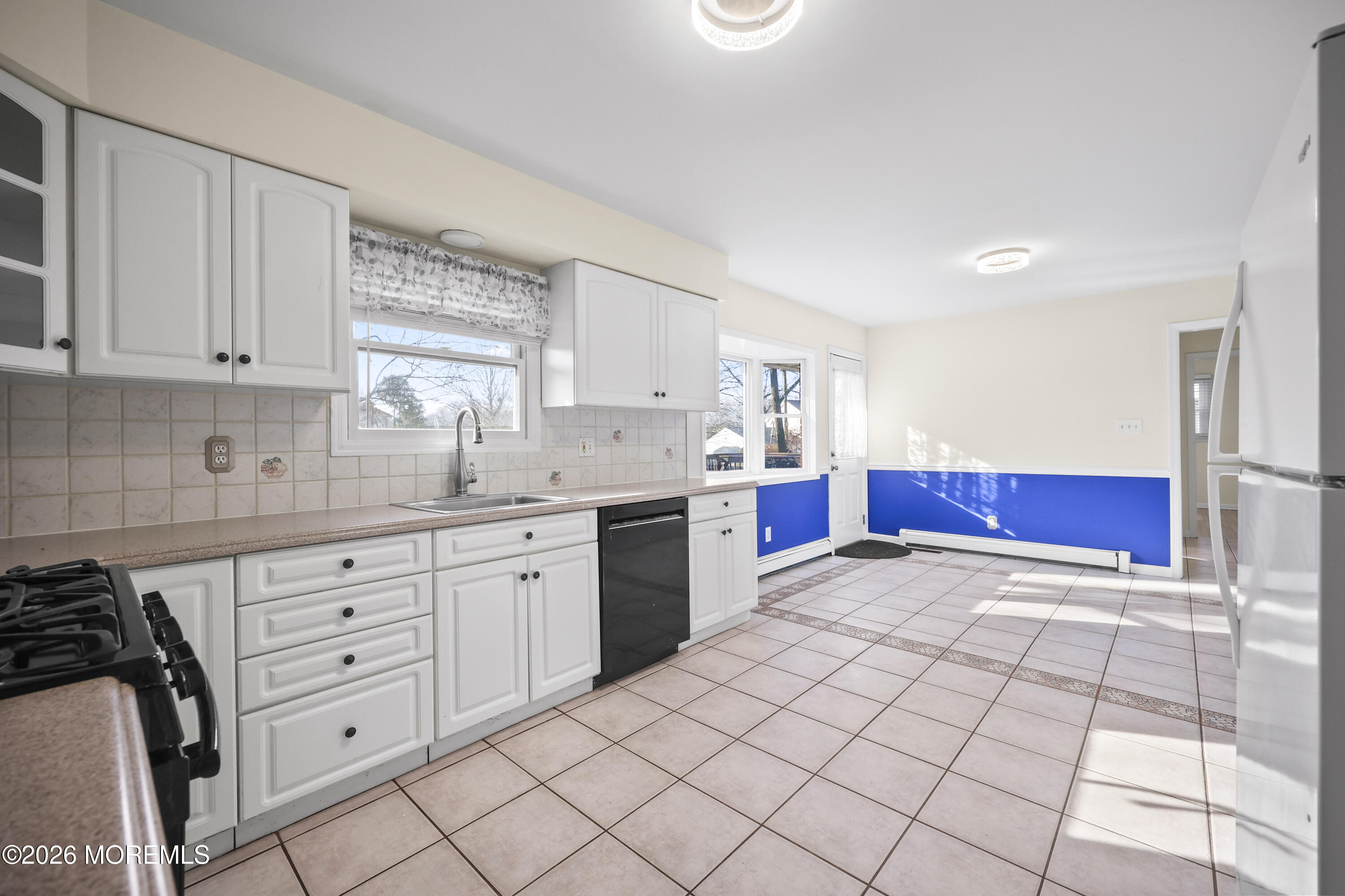 573 Lloyd Road Aberdeen, NJ 07747 - Photo 8 of 23 a kitchen with granite countertop a sink cabinets and window