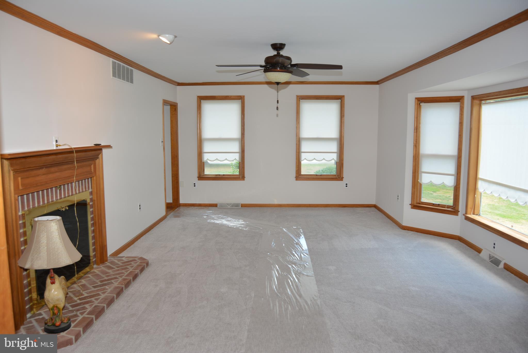 469 Red Lion Road Southampton, NJ 08088 - Photo 13 of 45 a view of an empty room with a fireplace and a window