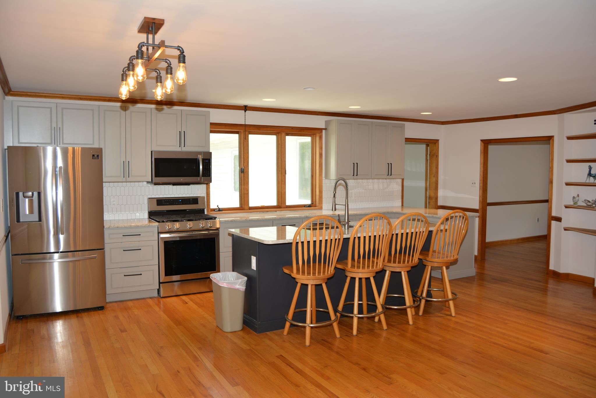 469 Red Lion Road Southampton, NJ 08088 - Photo 5 of 45 a kitchen with stainless steel appliances a dining table chairs stove refrigerator and microwave
