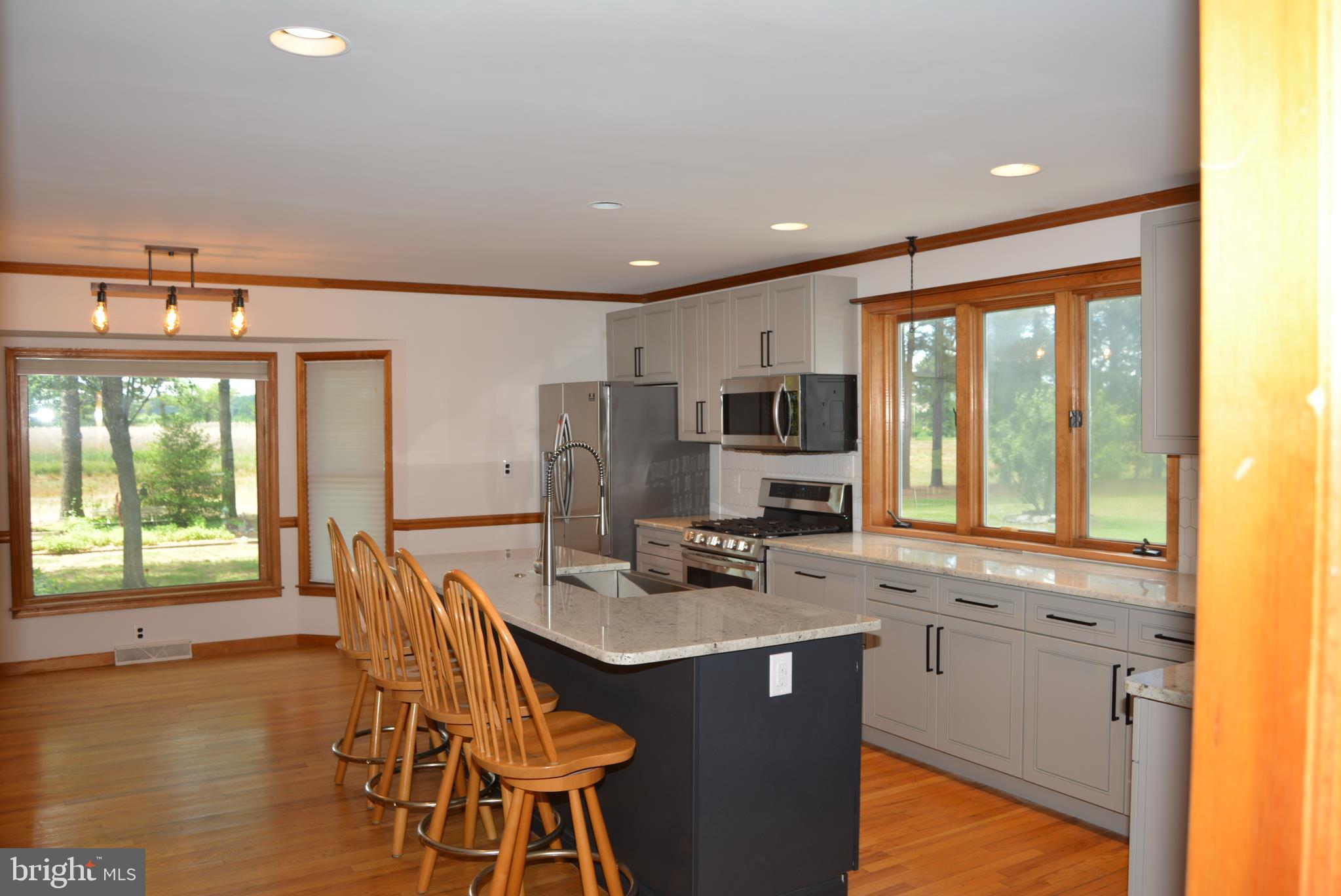 469 Red Lion Road Southampton, NJ 08088 - Photo 7 of 45 a kitchen with stainless steel appliances granite countertop a stove a refrigerator a sink dishwasher with a dining table and chairs with wooden floor