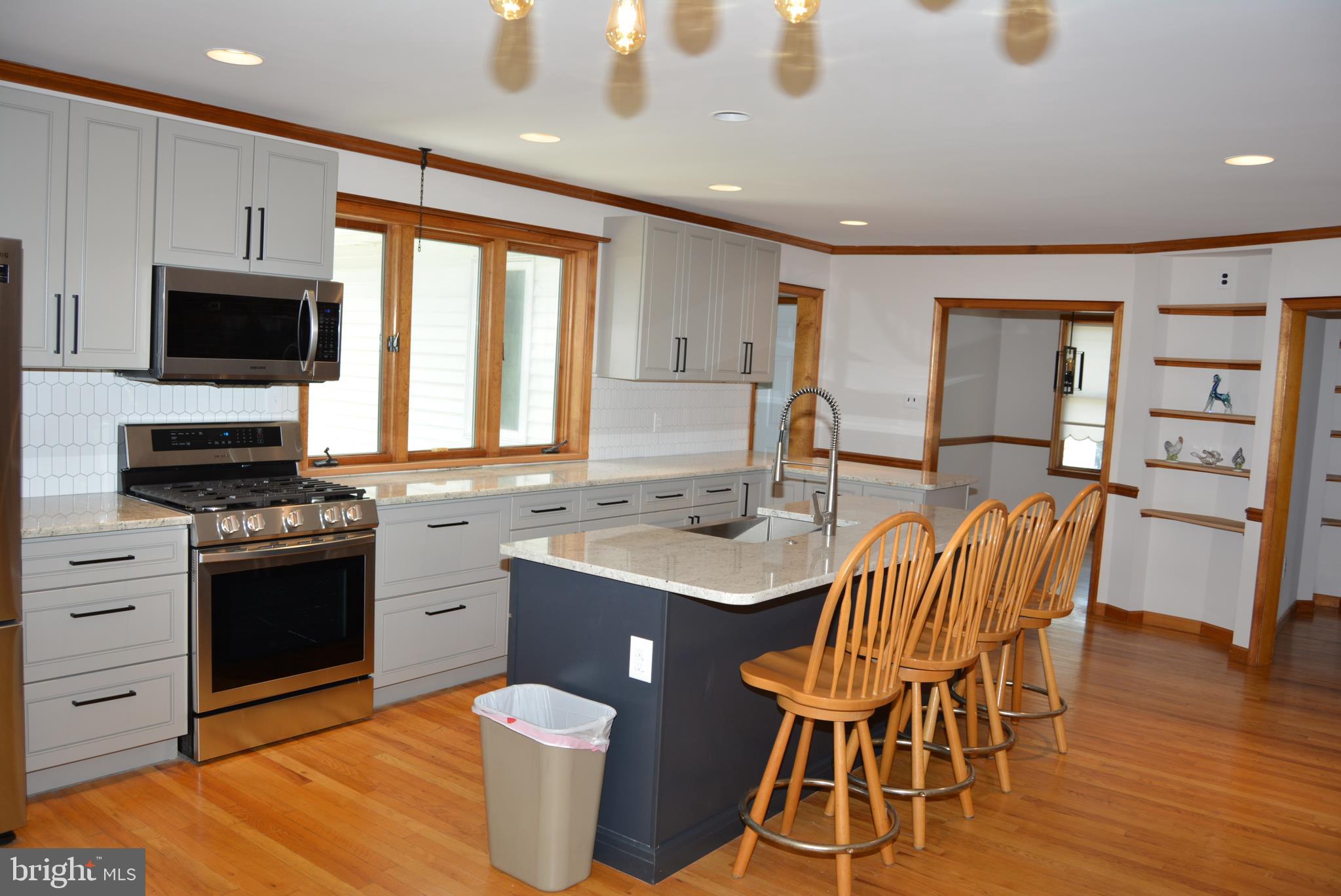 469 Red Lion Road Southampton, NJ 08088 - Photo 8 of 45 a kitchen with stainless steel appliances granite countertop a stove a sink a microwave a dining table and chairs