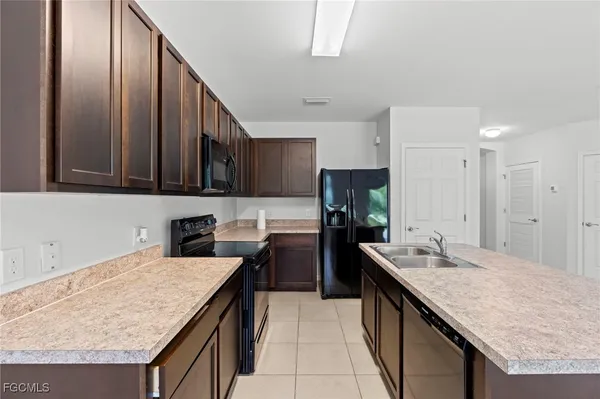 a kitchen with refrigerator and cabinets