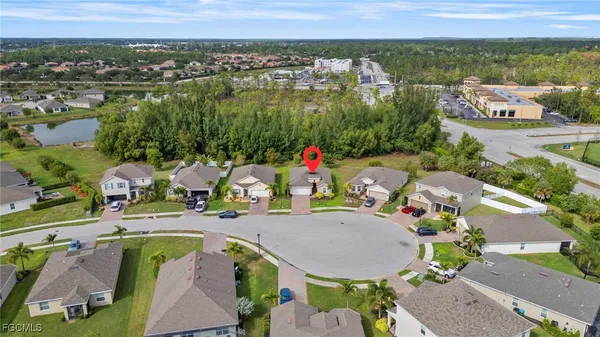 an aerial view of a house with outdoor space and lake view