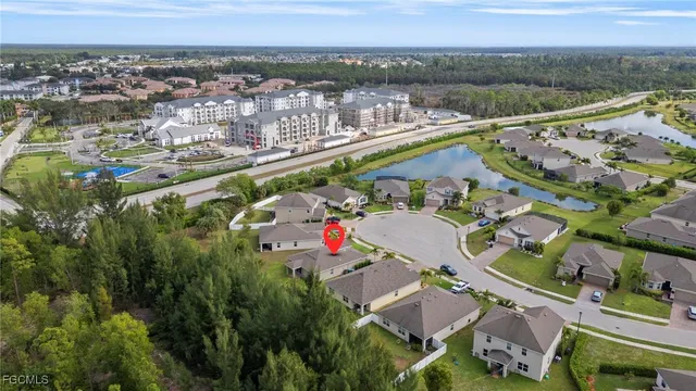 an aerial view of a houses with a lake