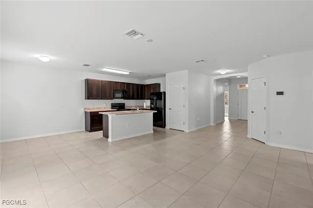 a view of kitchen with cabinets and window