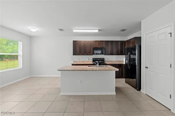 a kitchen with stainless steel appliances granite countertop a stove a refrigerator and a microwave