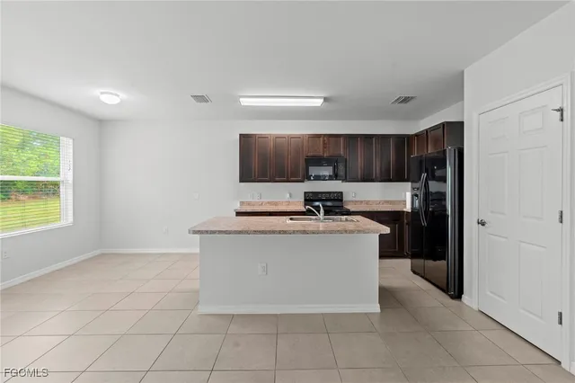 a kitchen with stainless steel appliances granite countertop a stove a refrigerator and a microwave