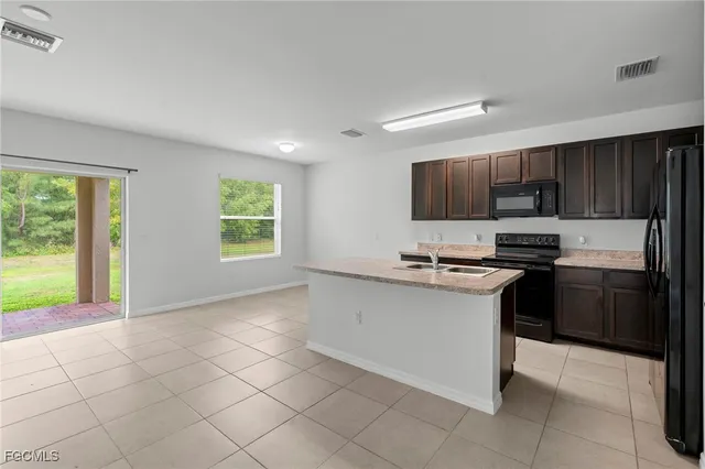 a kitchen with stainless steel appliances granite countertop a stove and a sink