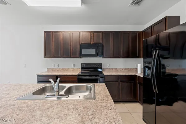 a kitchen with a sink a stove and refrigerator