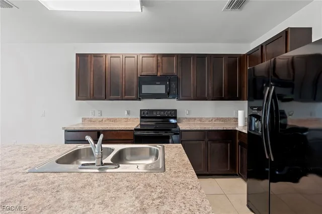 a kitchen with a sink a stove and refrigerator