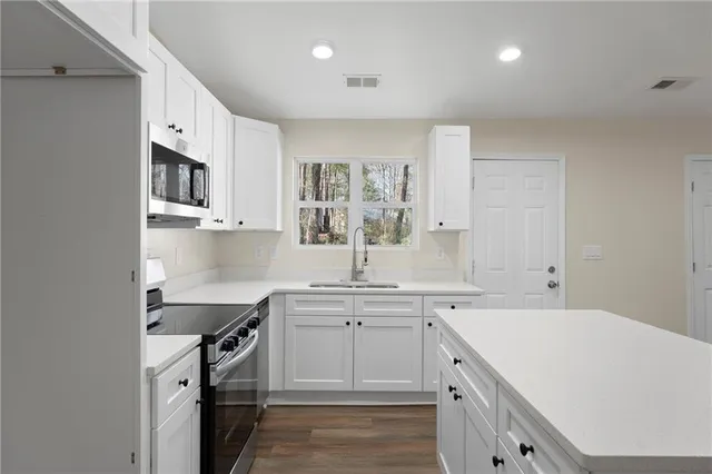 a kitchen with a sink stove and cabinets