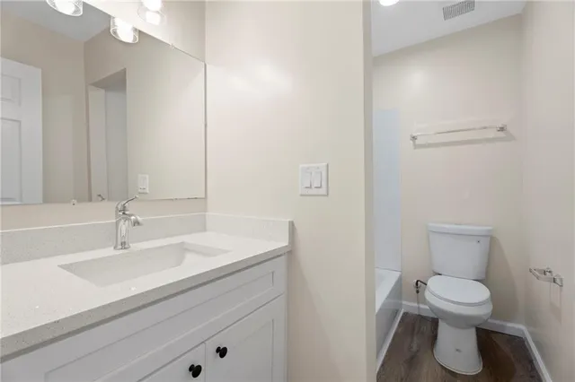 a bathroom with a sink toilet and vanity