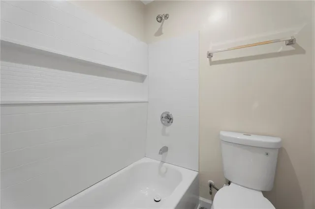 a bathroom with a toilet and a bathtub