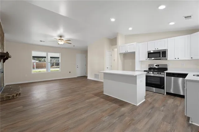 a kitchen with a refrigerator and a stove top oven
