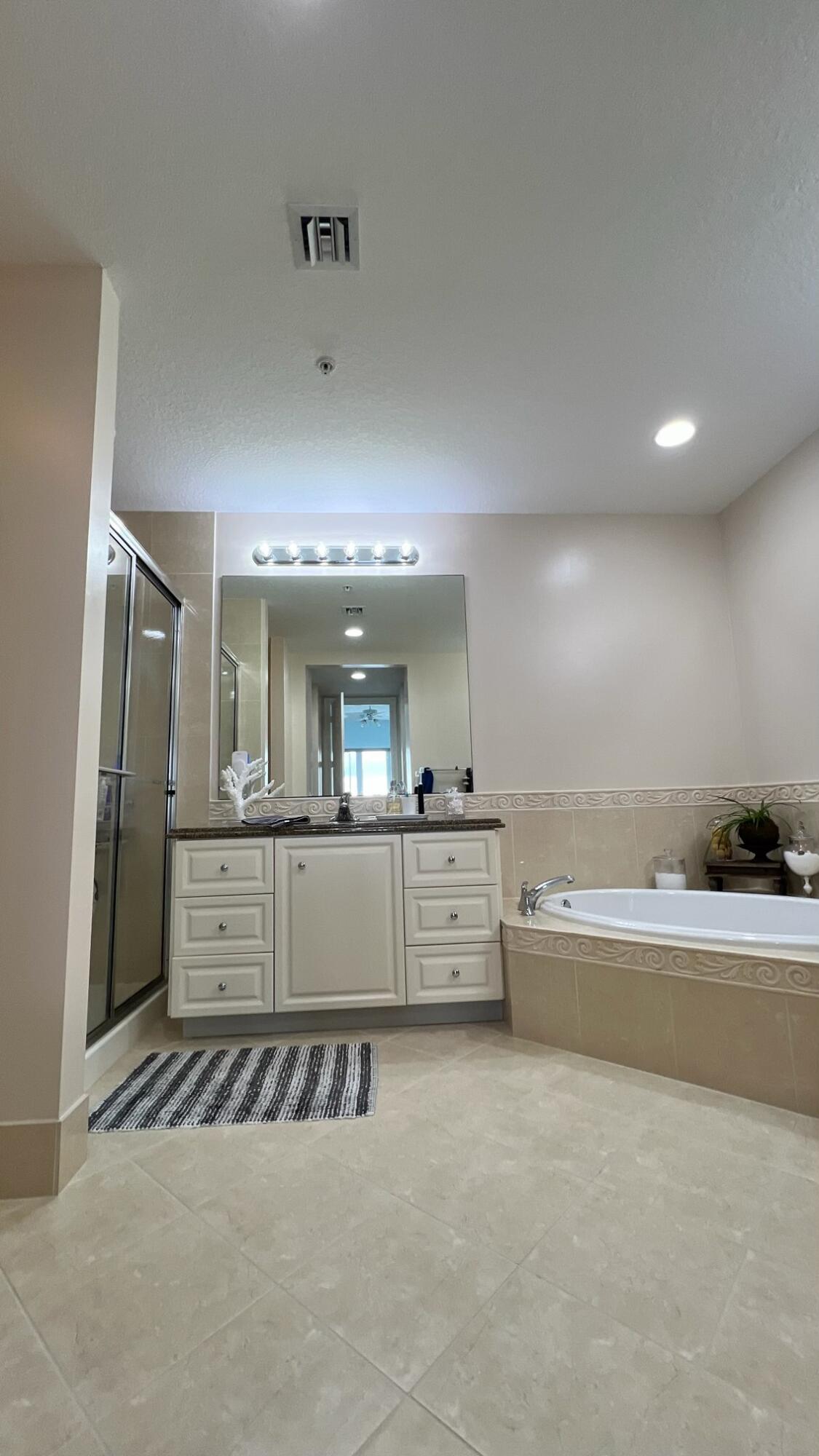 31 Harbour Isle Drive West, Unit 303 Fort Pierce, FL 34949 - Photo 15 of 31 a large room with a large window and furniture