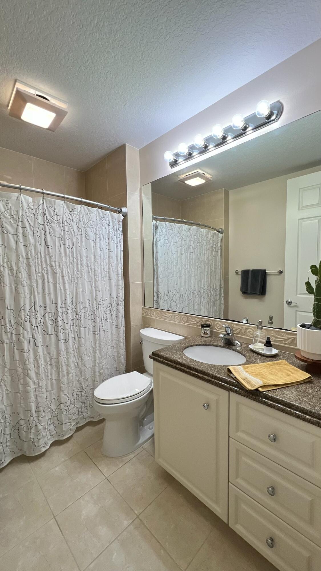 31 Harbour Isle Drive West, Unit 303 Fort Pierce, FL 34949 - Photo 17 of 31 a bathroom with a double vanity sink and a mirror