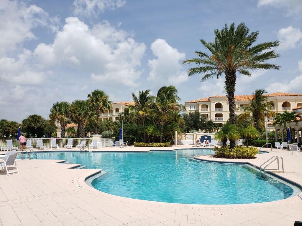 31 Harbour Isle Drive West, Unit 303 Fort Pierce, FL 34949 - Photo 24 of 31 a view of a swimming pool with a yard