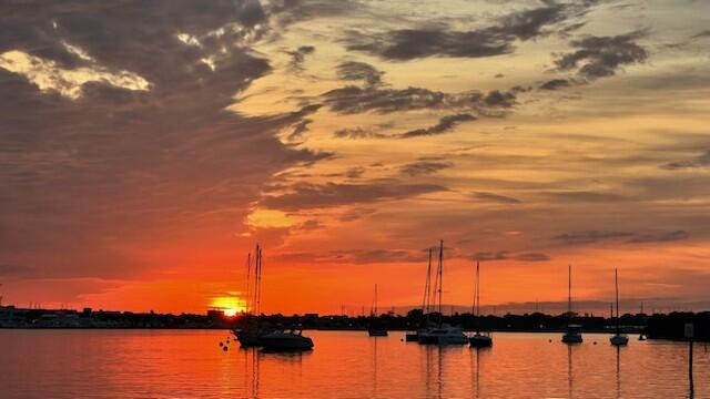 31 Harbour Isle Drive West, Unit 303 Fort Pierce, FL 34949 - Photo 29 of 31 a view of ocean with boats and trees in the background