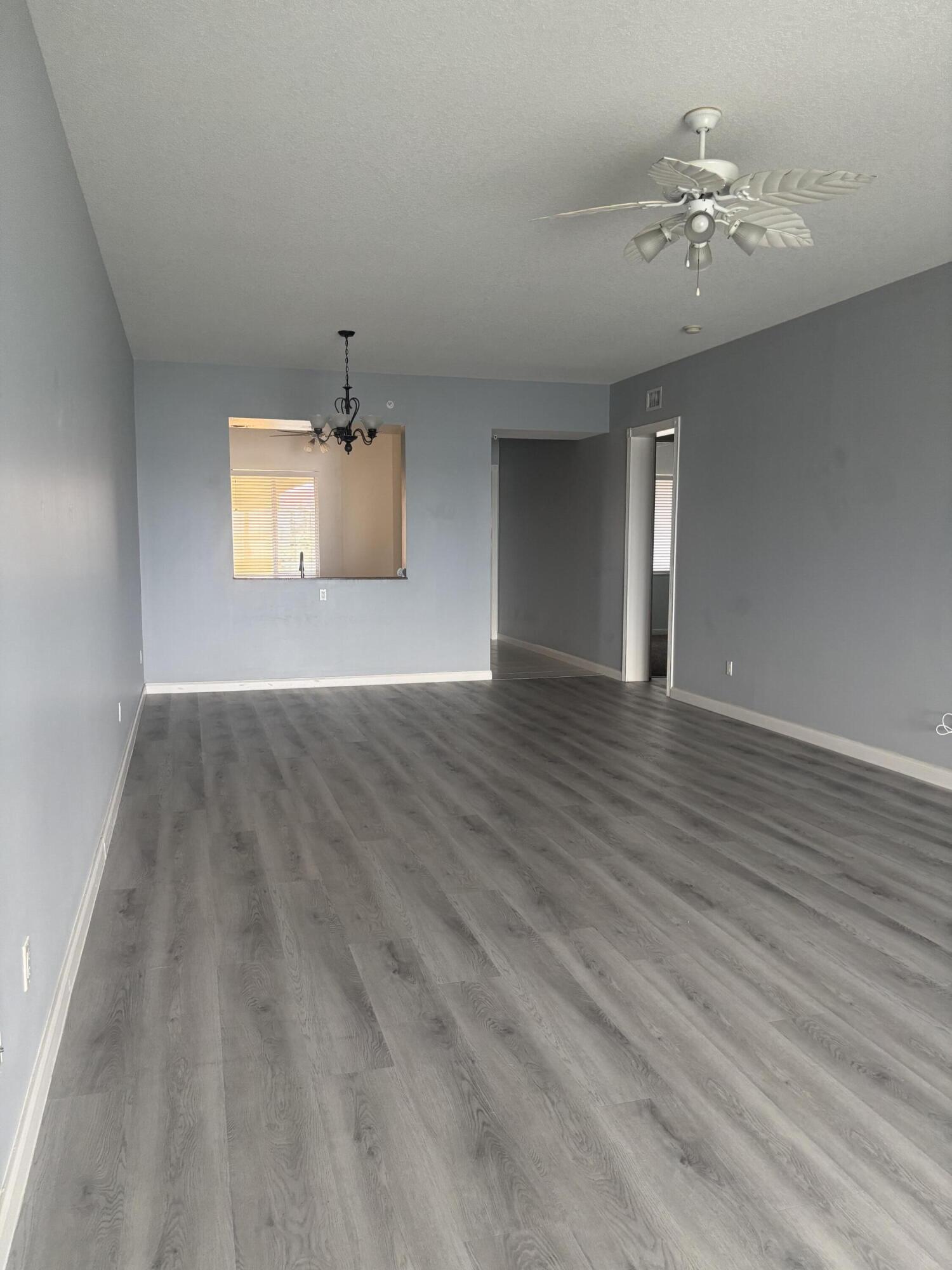 31 Harbour Isle Drive West, Unit 303 Fort Pierce, FL 34949 - Photo 7 of 31 wooden floor in an empty room with a window