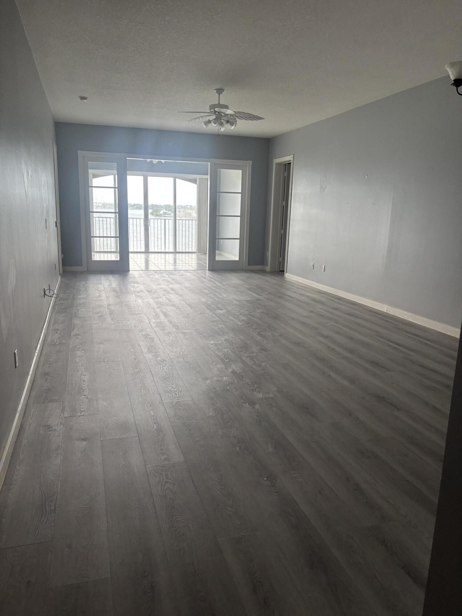 31 Harbour Isle Drive West, Unit 303 Fort Pierce, FL 34949 - Photo 8 of 31 wooden floor in an empty room with a window