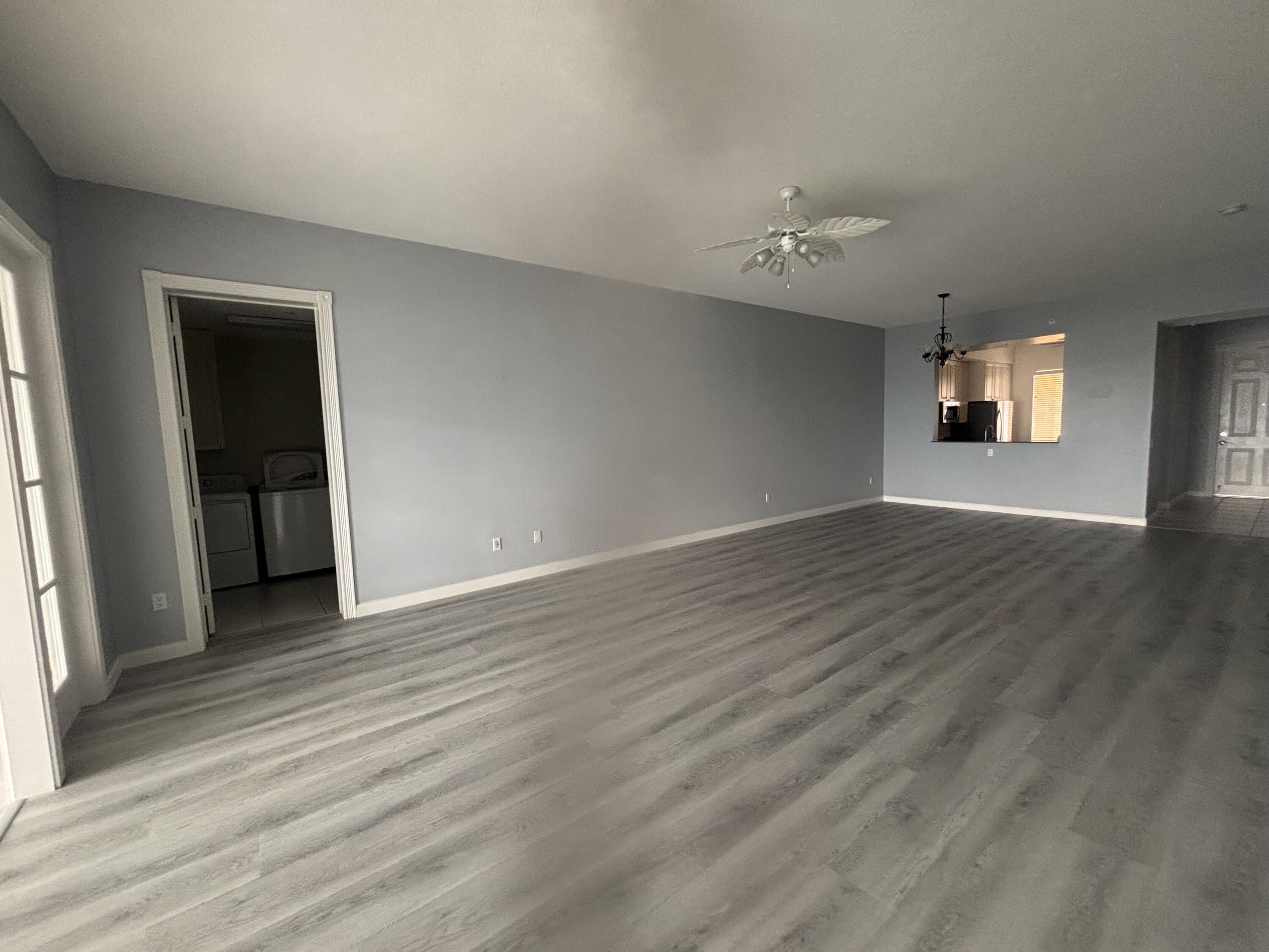 31 Harbour Isle Drive West, Unit 303 Fort Pierce, FL 34949 - Photo 9 of 31 an empty room with wooden floor and windows