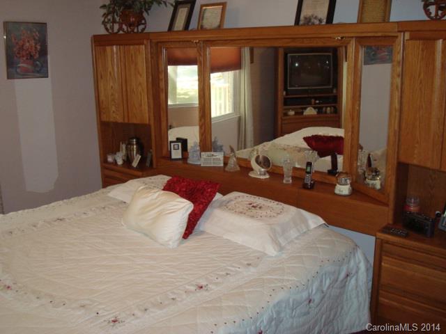 3205 Puetts Chapel Road Dallas, NC 28034 - Photo 12 of 24 a bedroom with a bed window and mirror