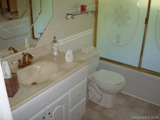 3205 Puetts Chapel Road Dallas, NC 28034 - Photo 16 of 24 a bathroom with a sink a toilet and shower