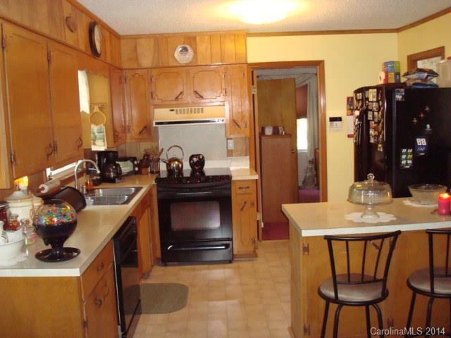 3205 Puetts Chapel Road Dallas, NC 28034 - Photo 4 of 24 a kitchen with a table chairs and cabinets