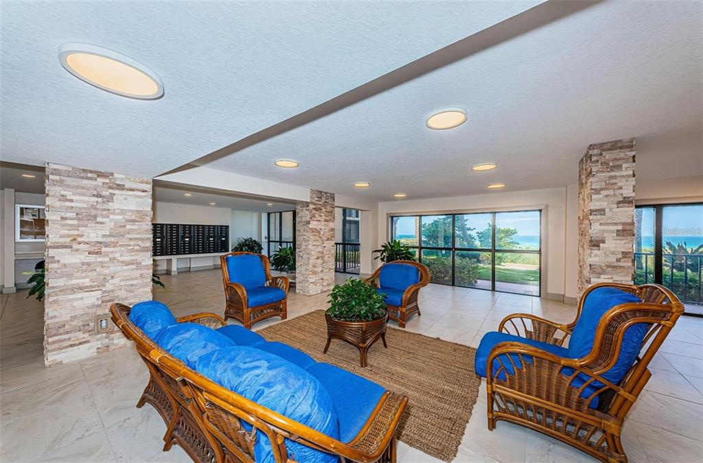 900 Gulf Boulevard, Unit 907 Indian Rocks Beach, FL 33785 - Photo 63 of 88 a living room with furniture a rug and a large window