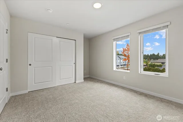 an empty room with windows and closet