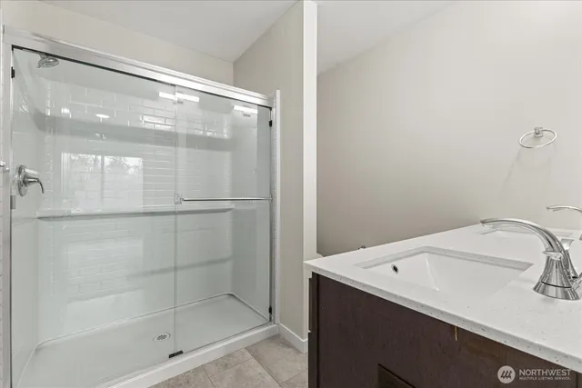 a bathroom with a sink and shower