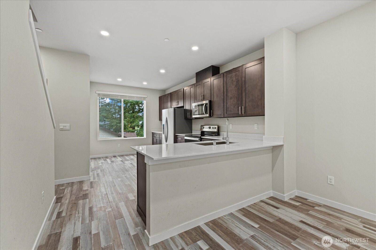 1831 100th Street Southwest, Unit B Everett, WA 98204 - Photo 9 of 27 a kitchen with stainless steel appliances granite countertop a sink stove and refrigerator