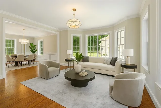a living room with couches and a dining table with wooden floor