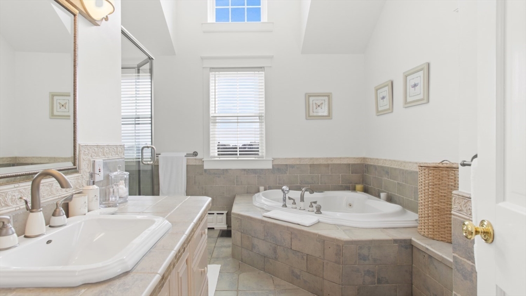 26 Old Tom Nevers Road, Unit 1 Nantucket, MA 02554 - Photo 12 of 31 a bathroom with a tub sink and mirror