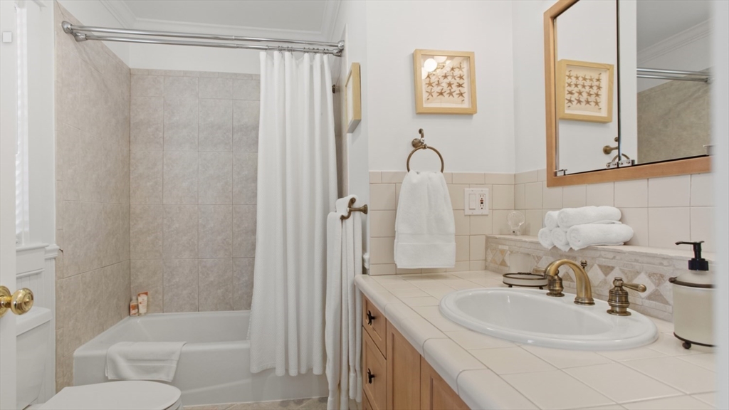 26 Old Tom Nevers Road, Unit 1 Nantucket, MA 02554 - Photo 15 of 31 a bathroom with a sink a toilet and shower