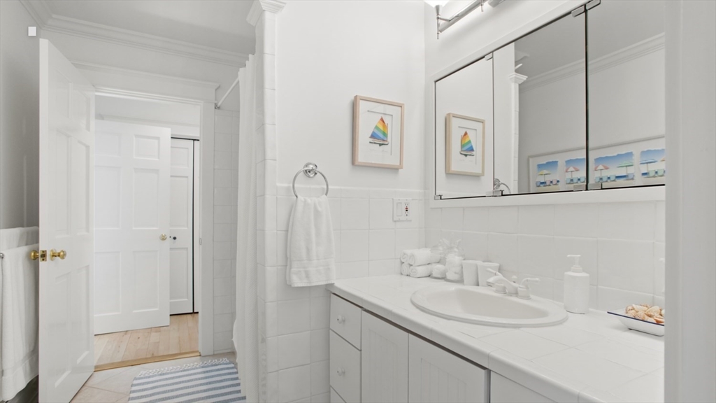 26 Old Tom Nevers Road, Unit 1 Nantucket, MA 02554 - Photo 16 of 31 a bathroom with a sink and a mirror