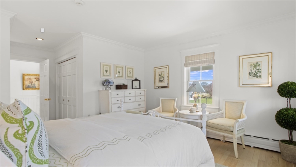 26 Old Tom Nevers Road, Unit 1 Nantucket, MA 02554 - Photo 17 of 31 a bedroom with a bed a couch and painting on the wall