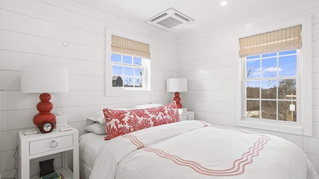 26 Old Tom Nevers Road, Unit 1 Nantucket, MA 02554 - Photo 21 of 31 a bedroom with a bed and window