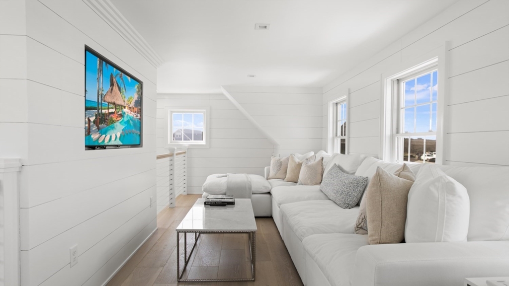 26 Old Tom Nevers Road, Unit 1 Nantucket, MA 02554 - Photo 26 of 31 a living room with furniture and a painting on the wall