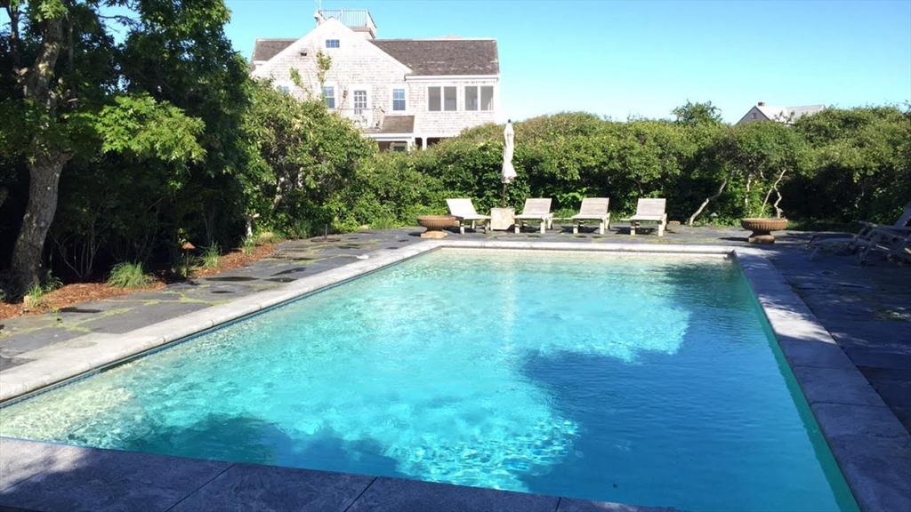 26 Old Tom Nevers Road, Unit 1 Nantucket, MA 02554 - Photo 4 of 31 a view of a swimming pool with a patio