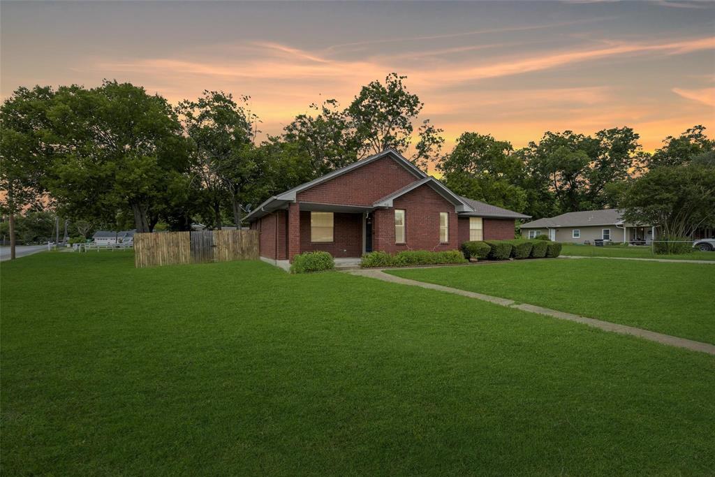 918 Prairie Avenue Cleburne, TX 76033 - Photo 2 of 25 a front view of a house with a garden and yard