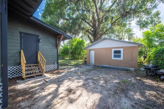 a view of a house with a yard and tree