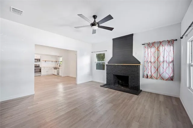 wooden floor fireplace and windows in a room